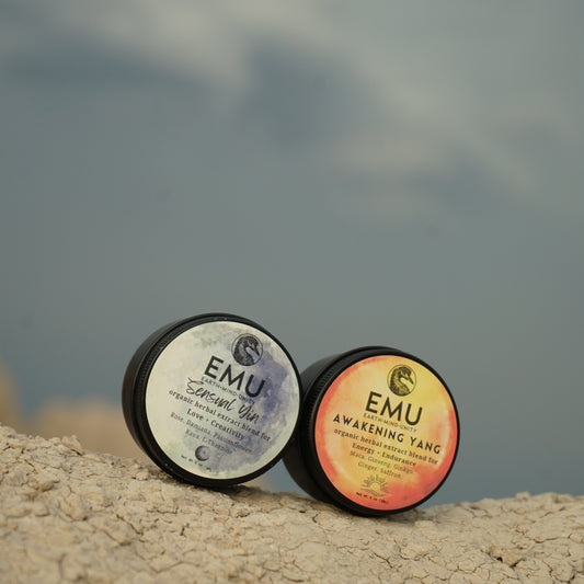 Two EMU products on a rocky surface with a blurred natural background
